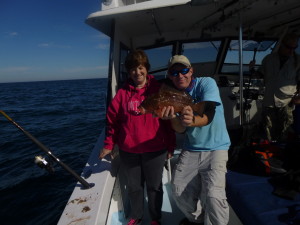 Offshore with Kingfisher Fleet and mate, Matt holds one of the 15-grouper caught and released by Barb!