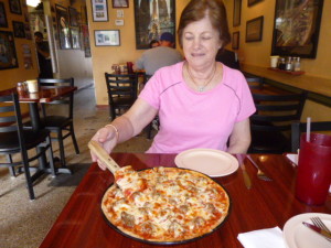 Barb is digging in to a Chicago sausage pizza!
