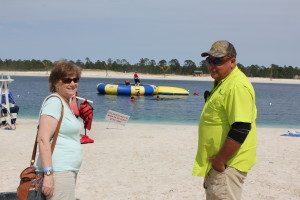 Barb and local down-home owner are enjoying the beach and watching children and their parent having fun!