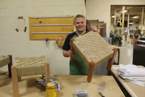 Student Zach Smith shows off some of his and other craft students handiwork to be sold at  the College Crafts Center Store.